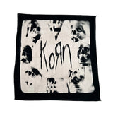 Black and white bandana with skull designs and the word 'Korn' on a white background