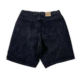 Back view of dark black denim shorts with a tan Lee brand patch on the waistband, laid flat on a white background.