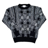 Black and gray patterned sweater on a white background