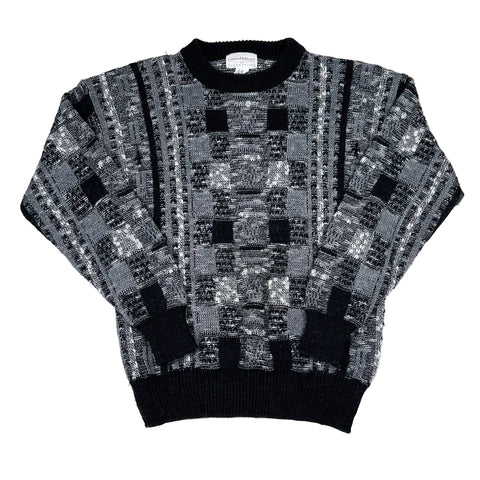 Black and gray patterned sweater on a white background