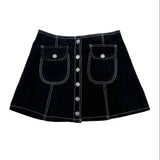 A black denim mini skirt with white contrast stitching, featuring two front patch pockets with silver snap buttons and a central button closure, laid flat on a white background.