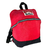A red and black backpack featuring a prominent Marlboro logo patch on the front, photographed against a neutral light gray background.