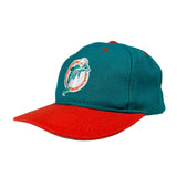 Teal and red cap with a dolphin logo on a white background