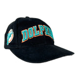 A black baseball cap featuring 'DOLPHIN' embroidered in teal with an orange outline on the front, and a Miami Dolphins logo patch on the side, set against a plain white background.