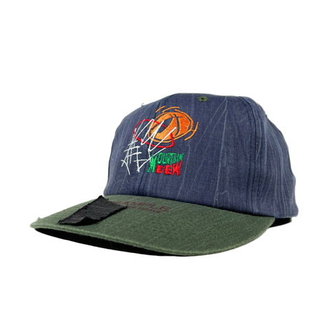 Blue and green cap with embroidered design on a white background