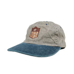Gray and blue cap with an embroidered logo on a white background