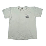 A light beige crewneck t-shirt with 'the nano expanded cinema' printed in black text on the left chest, laid flat on a white background.