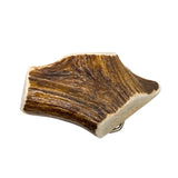 Wooden carving of a leaf on a white background