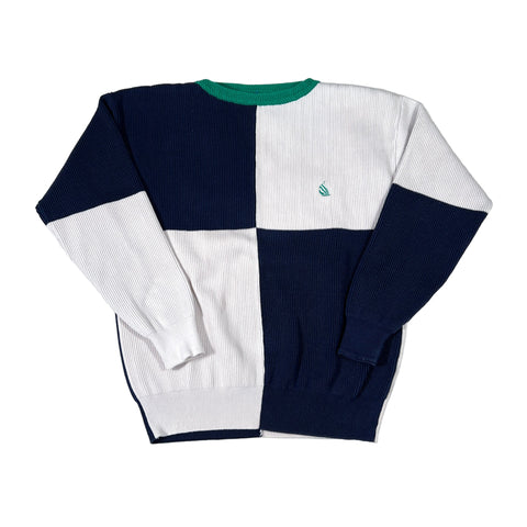 Color-blocked sweater with navy, white, and green sections on a white background