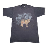A dark charcoal gray short-sleeve t-shirt featuring a graphic print of wolves, with a coyote in the foreground and the text 'New Mexico' printed below it.