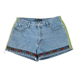 Blue denim shorts with floral embroidery on a white background