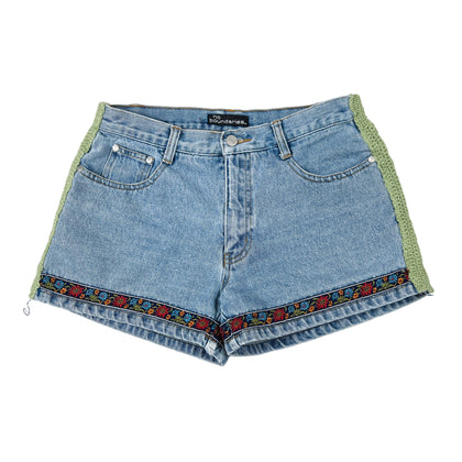 Blue denim shorts with floral embroidery on a white background