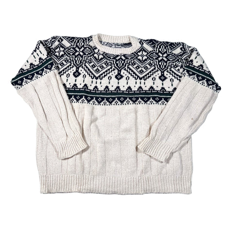 Beige sweater with black and white pattern on a white background