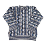 Blue and gray patterned sweater on a white background