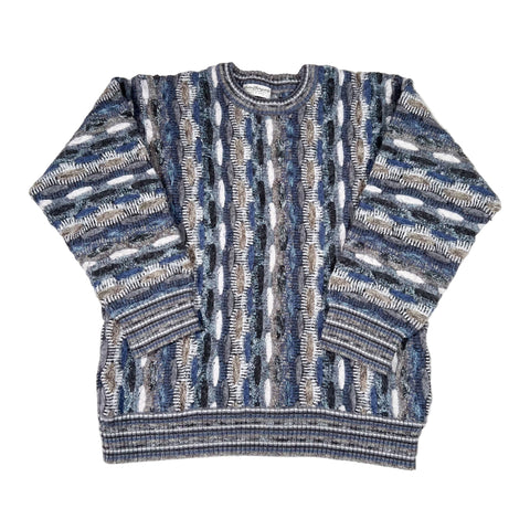 Blue and gray patterned sweater on a white background