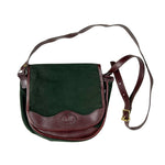 Green and brown leather crossbody bag on a white background