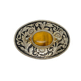 Decorative belt buckle with floral patterns and a yellow stone on a white background