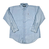 Light blue button-up shirt with rolled-up sleeves on a white background