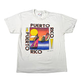 A white short-sleeve graphic t-shirt laid flat on a white background. The front features a colorful Puerto Rico sailboat graphic with the text 'PUERTO RICO' printed vertically on both sides.