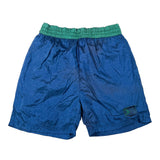 Blue athletic shorts with a green elastic waistband, laid flat on a white background.