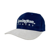 Two-toned blue and gray cap with 'Remington Country' logo on a white background