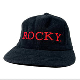 Black bucket hat with 'ROCKY' embroidered in red on a white background