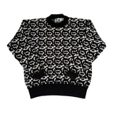 Black and white patterned sweater on a light gray background