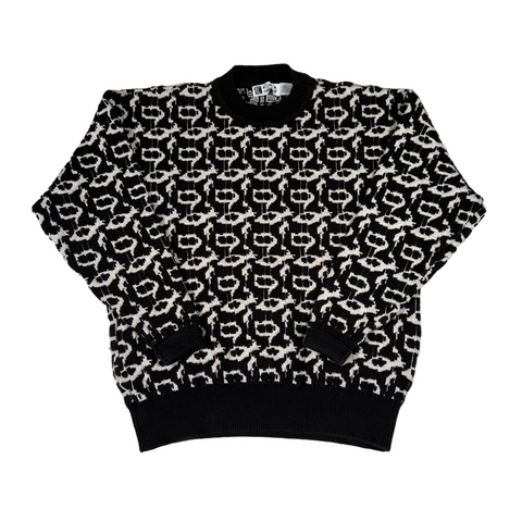 Black and white patterned sweater on a light gray background