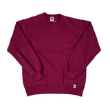 Folded maroon polo shirt with a small logo on a white background