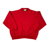 Folded red sweatshirt with a brand logo on a white background