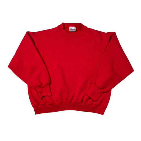 Folded red sweatshirt with a brand logo on a white background