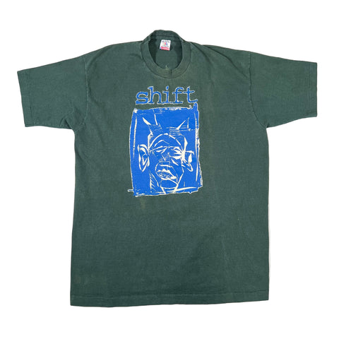 Green t-shirt with blue graphic and 'shift' text on a white background