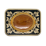 Decorative belt buckle with gold and black design on a white background