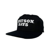 Black cap with 'Seton Hats' text on a white background