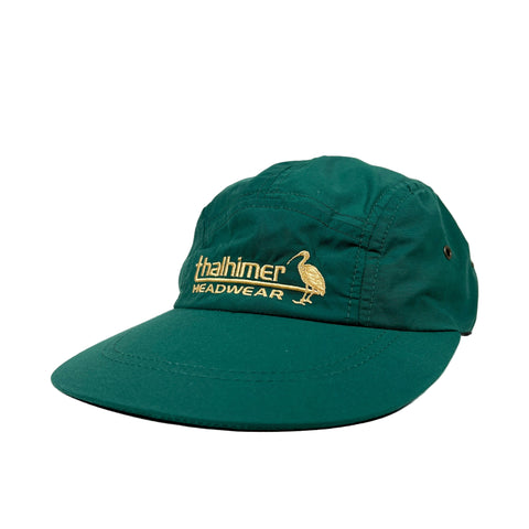 Green cap with gold logo and text on a white background