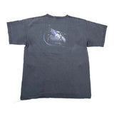 A faded dark gray short-sleeve t-shirt laid flat on a white surface, showing the back with a graphic print of a space shuttle and the text 'THE ORBIT' and 'JAMES TAYLOR'.