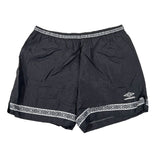 Black shorts with white geometric patterns and Umbro logo on a white background