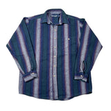 A long-sleeve button-up shirt with vertical stripes in dark teal, blue, and purple, laid flat on a white background.