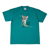 Teal t-shirt with a cat graphic and 'WHO, ME?' text on a white background