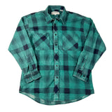 Green and navy plaid shirt on a white background
