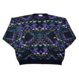 A vintage knit crewneck sweater with a complex geometric Fair Isle pattern in purple, black, teal, and gray, laid flat on a white background.