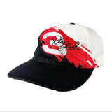 A vintage-style baseball cap with a black curved brim, featuring a white front panel with a red paint-splatter graphic and a black script logo that reads 'Elise Enchanted'.