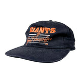 A vintage San Francisco Giants baseball cap in dark navy blue with orange and white embroidered lettering on the front, set against a plain light gray background.