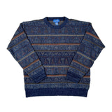 A vintage blue patterned knit sweater with horizontal stripes and geometric motifs, laid flat on a white background.