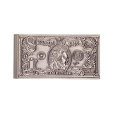 A silver-colored metal money clip designed to look like a vintage one-dollar bill, featuring embossed details of a central figure and decorative borders, shown on a white textured background.