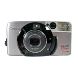 A silver Canon Sure Shot 105mm compact camera with a black lens ring, photographed on a clean white background.