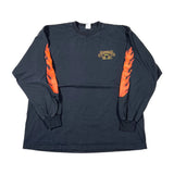 A black long-sleeve t-shirt with orange flame graphics on both sleeves and a small gold and black graphic on the left chest, laid flat on a white background.
