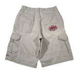 A pair of light beige cargo shorts shown from the back, featuring a red and black flame graphic embroidered on the right pocket, laid flat on a white background.