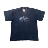 A faded black short-sleeve t-shirt with a blue and white graphic on the chest featuring a guitar and the text 'KISS ME KENZO JEANS FIT SIZZ'. The shirt is laid flat on a light gray background.