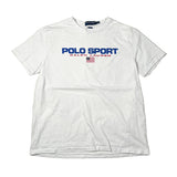 A white short-sleeve Polo Ralph Lauren t-shirt with 'POLO SPORT' printed in blue across the chest, 'RALPH LAUREN' in red below it, and a small American flag graphic. The shirt is laid flat on a light-colored surface.